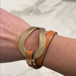 Tan leather and gold wrap bracelet.